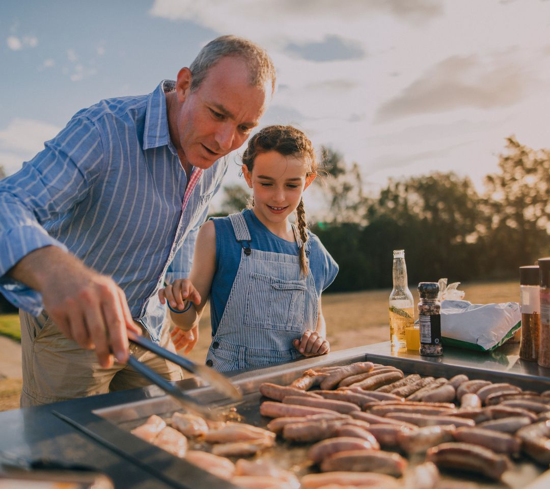 Dad and daughter grilling.