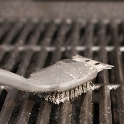 A brush scraping a grate.