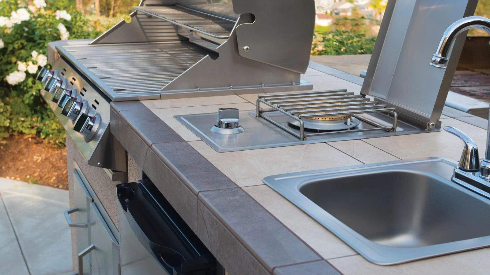 A grill with a sink.